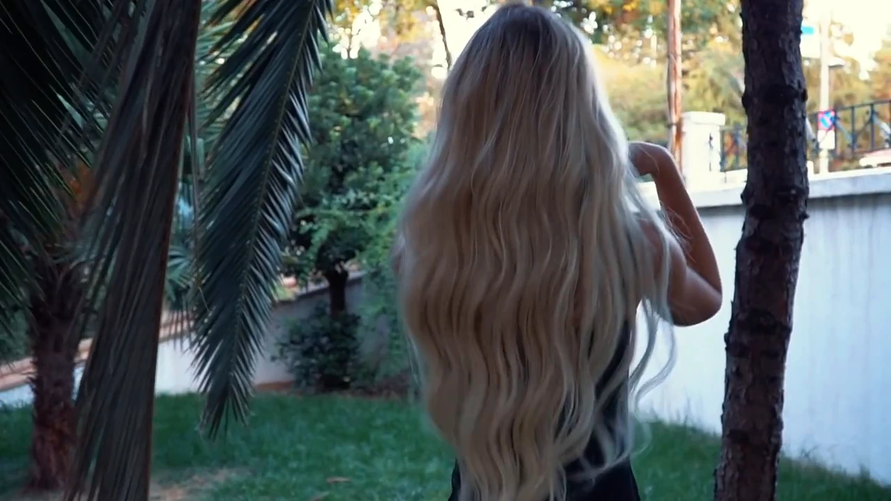 Close portrait of blonde model wearing long Butterfly tape-in hair extensions