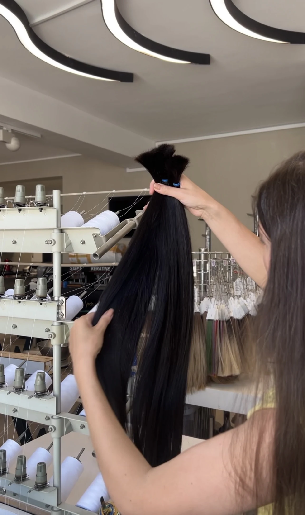Human hair bundles being inspected during preparation