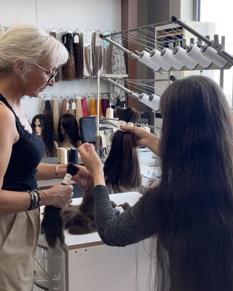 Hair being selected and prepared for extension production